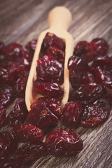 Vintage photo, Heap of red cranberries with spoon on wooden table