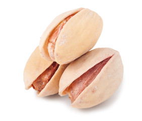 Three pistachios isolated on white background close-up macro