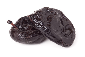 two dried prunes isolated on a white background closeup macro