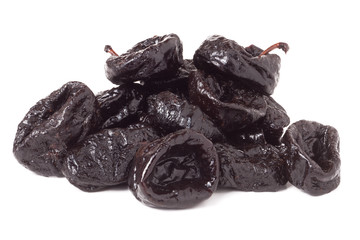 heap of dried prunes isolated on a white background closeup