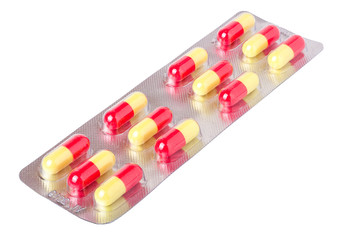 packing with red and yellow pills on white background