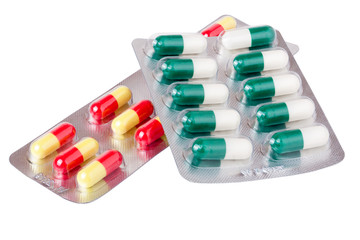 two packages with red green yellow pills on white background