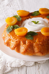 French pastries: Savarin with decorated apricots and mint close-up. vertical
