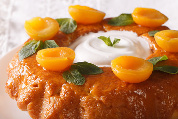 Savarin French dessert with apricots and whipped cream macro. Horizontal
