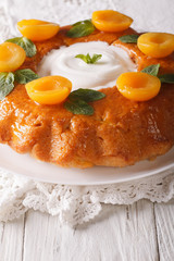 French Savarin cake decorated with apricots and mint close-up. vertical
