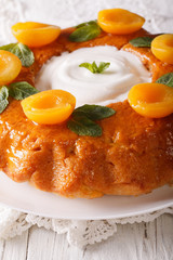 Savarin French dessert with apricots and whipped cream close-up. vertical
