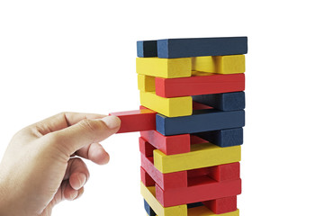 Fototapeta na wymiar male hand placing wooden block on a tower. planing and strategy concept