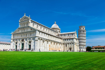 Tourists on Square of Miracles visiting Leaning Tower in Pisa, Italy. Leaning Tower of Pisa is campanile and is one of the most famous buildings in the world
