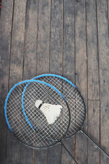 Shuttlecocks with badminton racket.