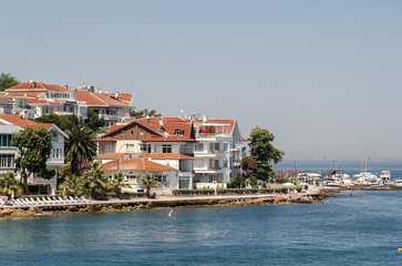 Obraz premium PRINCES ISLANDS, TURKEY - JULY 11, 2014 : View from the ferry, which runs along the route Istanbul - Buyukada. Architecture and tourists on the island Kinaliada