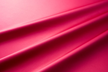 Fototapeta na wymiar 濃いピンク色のサテンのドレープ