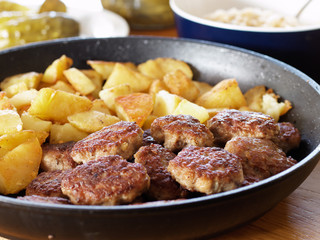 Fried potatoes and meatballs to the pan