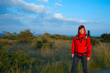 Naklejka premium Dreaming hiker in the sunset