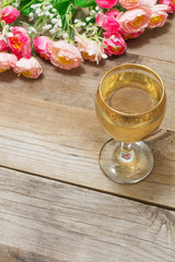 glass of white wine and flowers