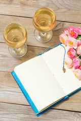 notepad, white wine and flowers
