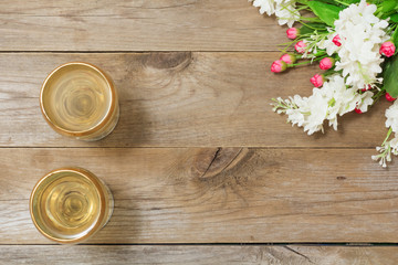 Two glasses of white wine and flowers