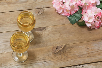 Two glasses of white wine and flowers
