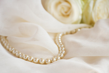 Wedding background with pearl beads and roses