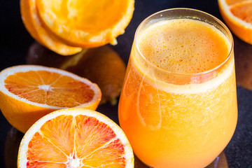 Fresh Orange Juice and Fruits on Dark Wooden Background