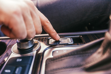 Close-up of a male hand  in a modern car
