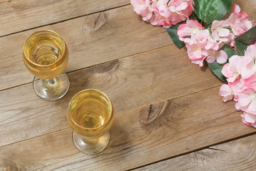 Two glasses of white wine and flowers