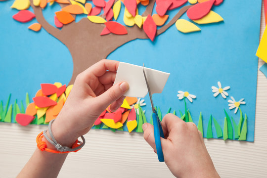 Closeup of child hands cutting rubber foam