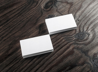 Photo of blank business cards on wooden background. Blank template for design presentations and portfolios.