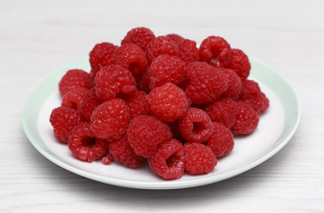 Fresh raspberries in white dish