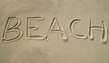 Beach written in letters in the sand