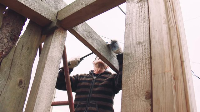 Man Midle Age in the Eyeglasses in the Country Doing Man's Job Day Autumn Closeup, Russia