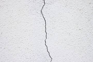 White wall with cracks in the middle, Split down the middle.