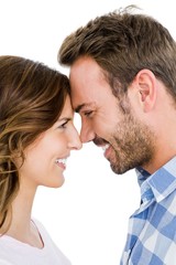 Happy young couple rubbing nose on white background