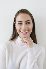 Smiling young woman in white top, portrait