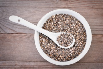 Chia seeds on wood background.   