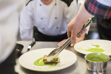 Chef applying dish on the plate