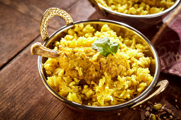 Bowl of chicken drumstick biryani and rice