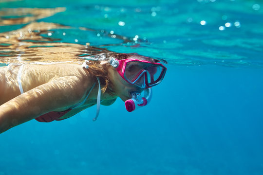 underwater portrait of young lady snorkeling in mask