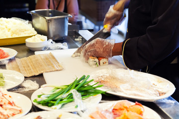 Preparing of traditional Japanese sushi, cutting