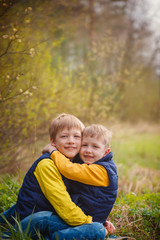 Fototapeta premium Portrait happy two brothers embracing in sunny day.