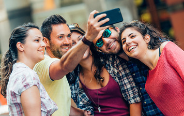 Selfie teenagers taking pictures in the city