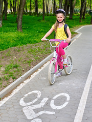 Bikes bicyclist girl. Girls wearing bicycle helmet  with rucksack ciclyng bicycle. Girls children...