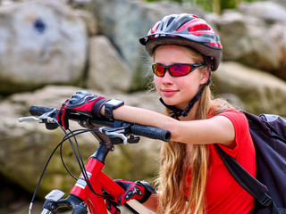 Bikes bicyclist girl. Bicyclist girl watch on smart watches. Girl counts pulse after bicycle training with help smart watches.