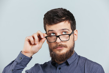 Fototapeta na wymiar Pensive man in glasses looking up