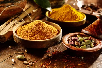 Tuinposter Curry and turmeric in bowls © exclusive-design
