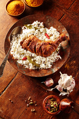 Overhead view of chicken tandoori and rice in a plate