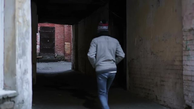 Hopelessly abandoned backstreet, lonely teenager walking alone, has no friends