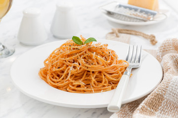 pasta with tomato sauce on a white plate
