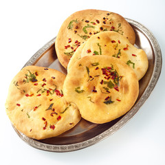Plate of naan bread on white surface