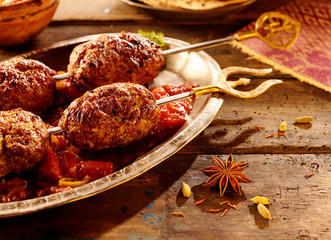 Close up on skewered meat with spices