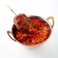 Cooked meat roll dipped in hot sauce